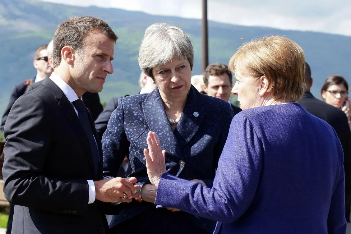 Photo showing French President Emmanuel Macron, British Prime Minister Theresa May, and German Chancellor Angela Merkel following a trilateral meeting on the sidelines of an EU-Western Balkans Summit in Sofia on May 17, 2018. (AFP)