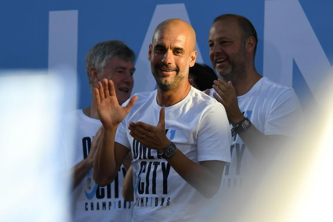 Manchester City’s Spanish manager Pep Guardiola celebrates winning the 2018 Premier League title with players and fans. If he completes five years at the Abu Dhabi-owned club, for which he has signed a contract extension, it would represent his longest tenure in a coaching job. (AFP)