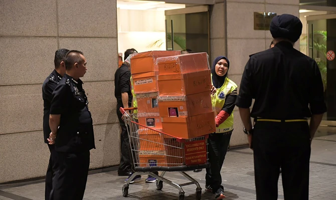 Cash-filled designer handbags seized in raids on former Malaysian PM’s apartments