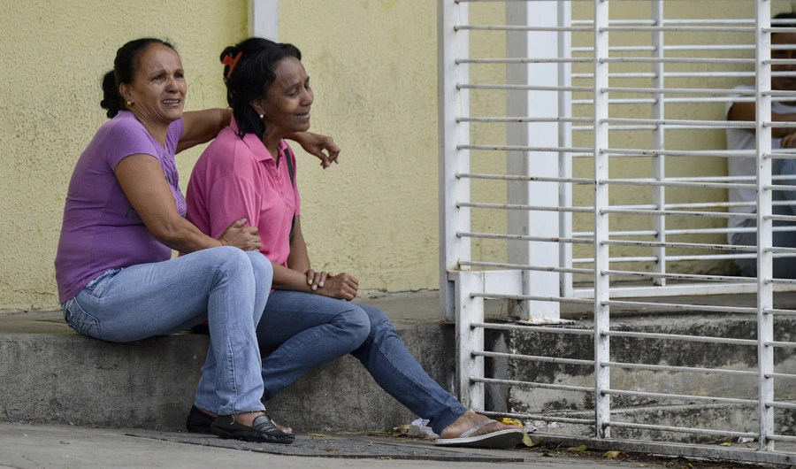 Relatives of inmates wait on May 18, 2018 outside the Fenix Community Penitentiary where a riot left at least 11 people dead on the eve, in the town of Irribarren, Lara State, in northern Venezuela. (AFP)