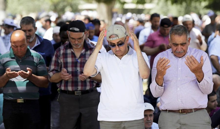 Palestinians pray in front at Al-Aqsa mosque compound during the first Friday of the holy month of Ramadan, in Jerusalem. (AP)