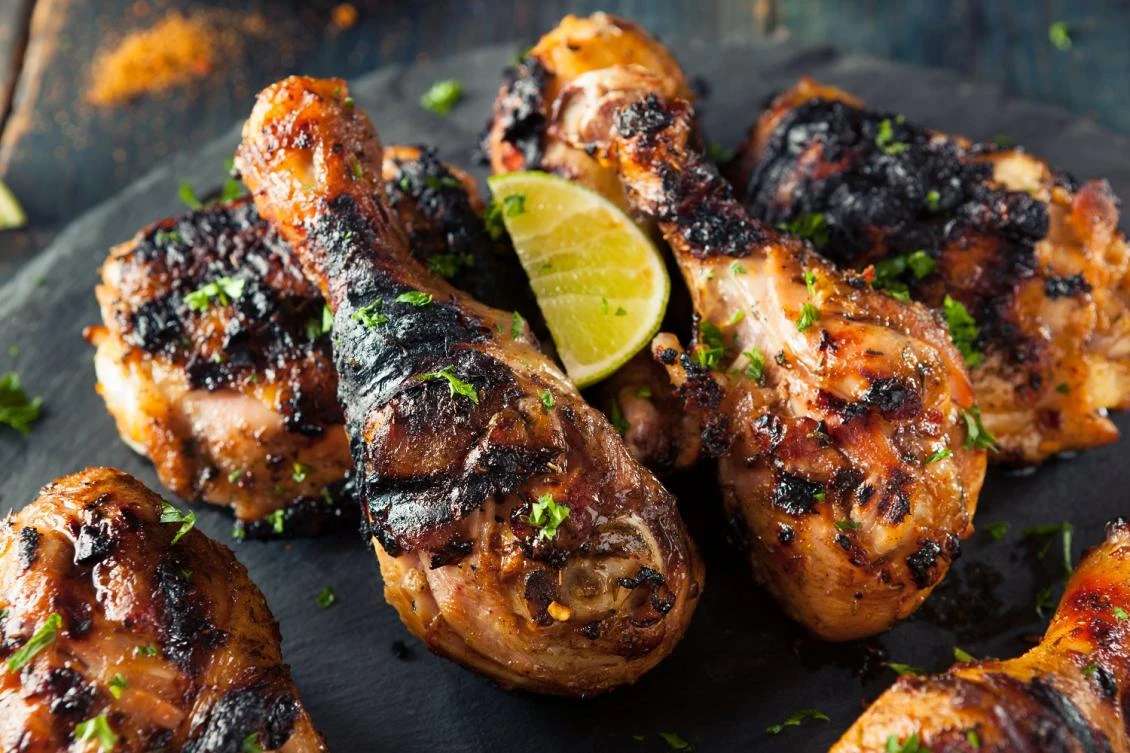 Jerk chicken was served with a side dish of sweet, pickled cucumber and acidic mango vinaigrette dipping sauce. (Shutterstock)