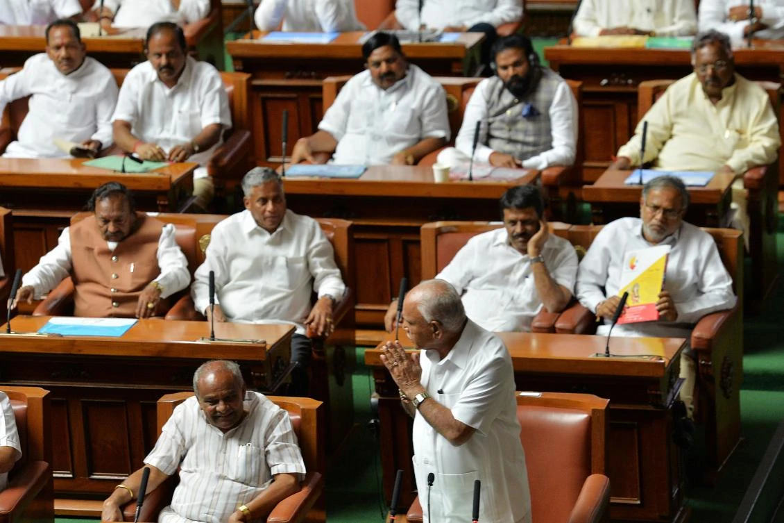 Chief Minister B.S. Yediyurappa (bottom R) of the Bharatiya Janata (BJP) party gestures after addressing the Karnataka State Legislative Assembly session before resigning from his post at Vidhana Soudha in Bangalore on May 19, 2018. (AFP)