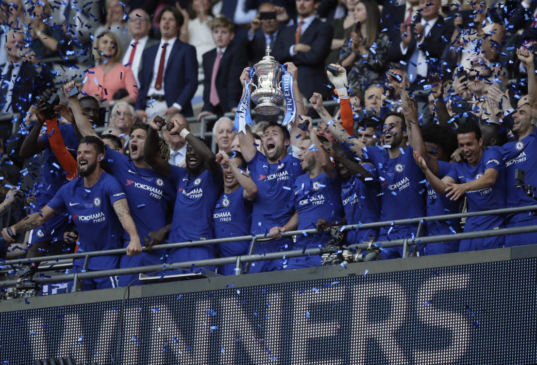 Chelsea's team captain Gary Cahill lifts the trophy after winning the English FA Cup final soccer match between Chelsea and Manchester United at Wembley stadium in London. (AP)