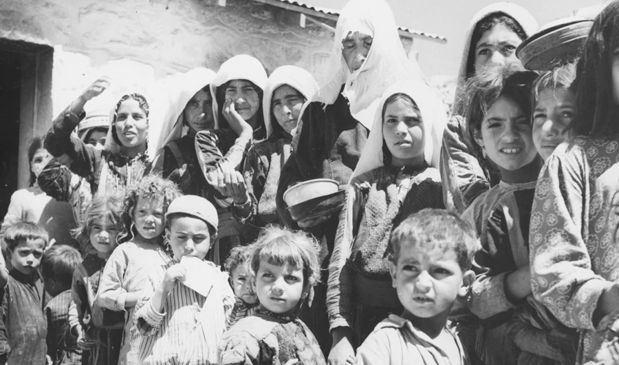 Palestinian refugees from Israel form a queue by the food tent in their camp in Amman. (Getty Images/file)