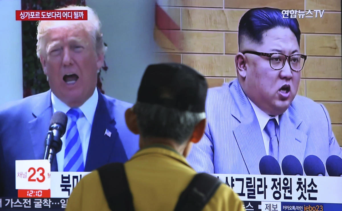 A man watches a TV screen showing file footage of US President Donald Trump, left, and North Korean leader Kim Jong Un during a news program at the Seoul Railway Station in Seoul, South Korea (AP/Ahn Young-joon)
