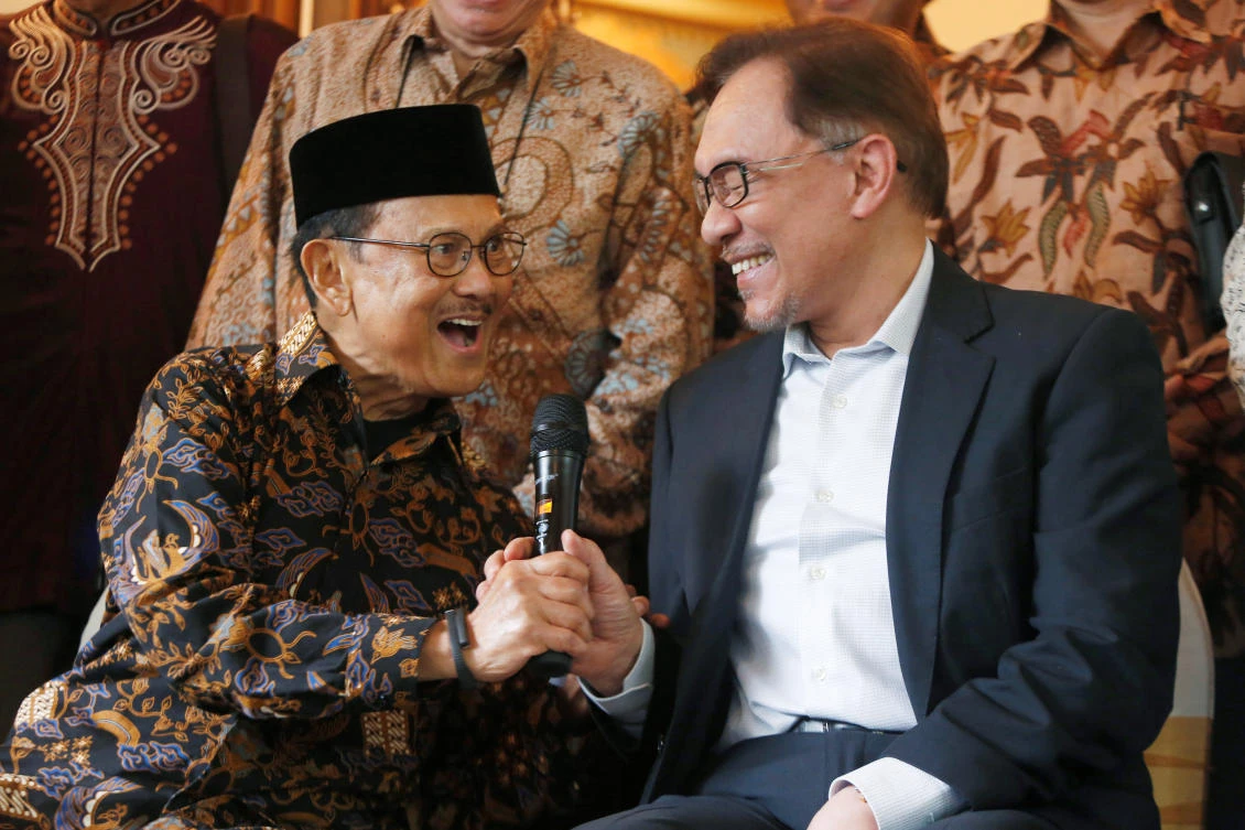 Malaysian politician Anwar Ibrahim (R) and former Indonesian President B.J. Habibie laugh while speaking with the media during his visit to Habibie's home in Jakarta, Indonesia May 20, 2018. (REUTERS)