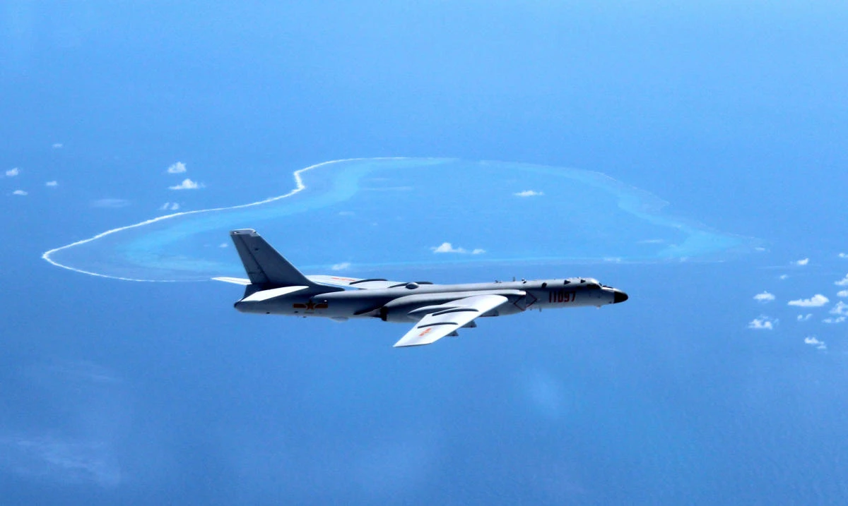 Above, a Chinese H-6K bomber patrols the islands and reefs in the South China Sea. (Xinhua via AP)