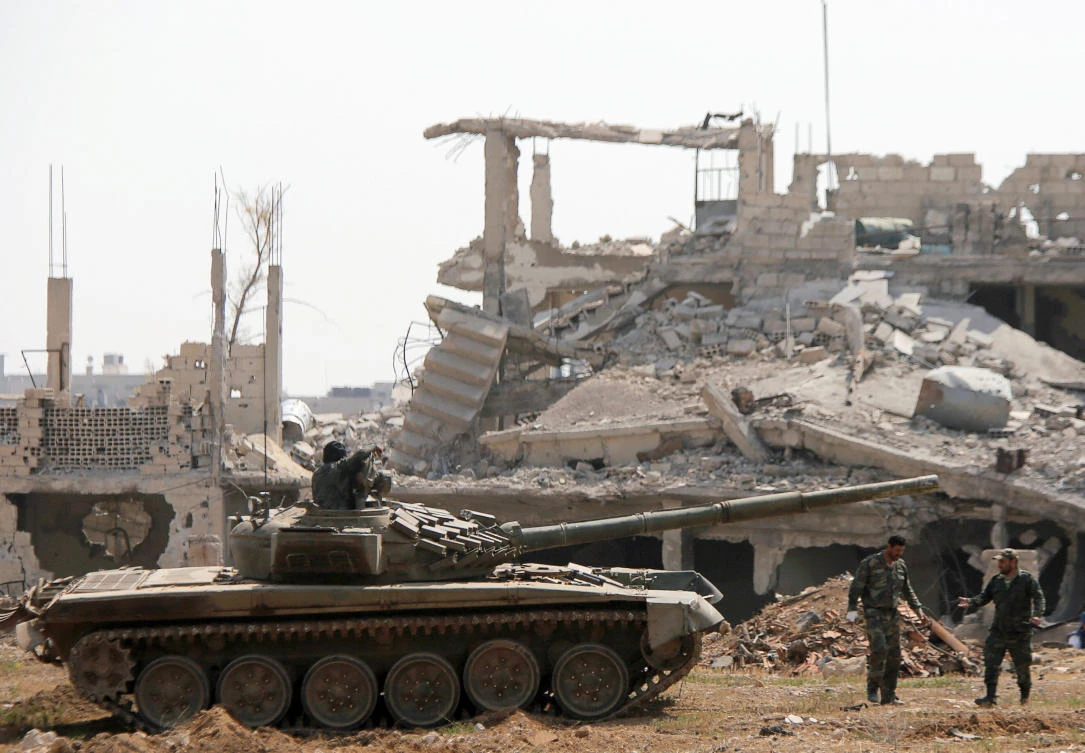 Soldiers loyal to Syria’s President Bashar Assad forces are deployed near the Yarmouk Palestinian camp in Damascus. The Syrian army and its allies have been battling for weeks to recapture the tiny Daesh enclave Al-Hajjar Al-Aswad. (Reuters)