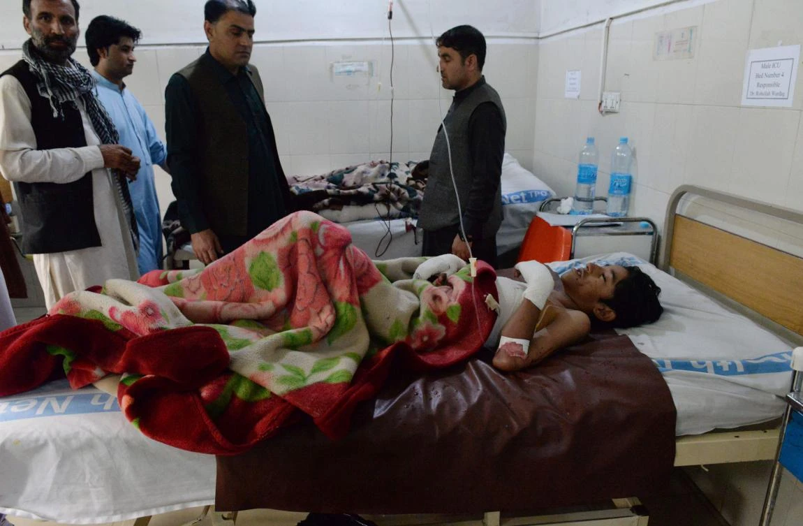 Afghan relatives look on as victims wounded in a suicide attack are treated at a hospital in Jalalabad on May 13, 2018. (AFP)
