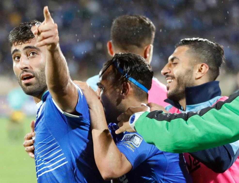 Esteghlal’s Iranian forward Kaveh Rezaei (L) celebrates with teammates after he scored during their AFC Champions League group B football match between Iran’s Esteghlal and UAE’s Al-Ahli in 2017 – he doesn’t even make the benches for the World Cup (AFP)