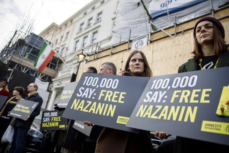 Campaigners hold posters demanding the release of British-Iranian woman Nazanin Zaghari-Ratcliffe, who is serving a five-year jail sentence in Iran for alleged sedition. (AFP)