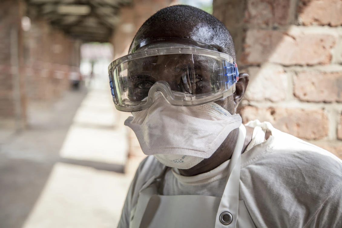 A health worker wears protective clothing outside an isolation ward to diagnose and treat suspected Ebola patients, at Bikoro Hospital in Bikoro, the rural area where the Ebola outbreak was announced last week, in Congo. (Mark Naftalin/UNICEF via AP)