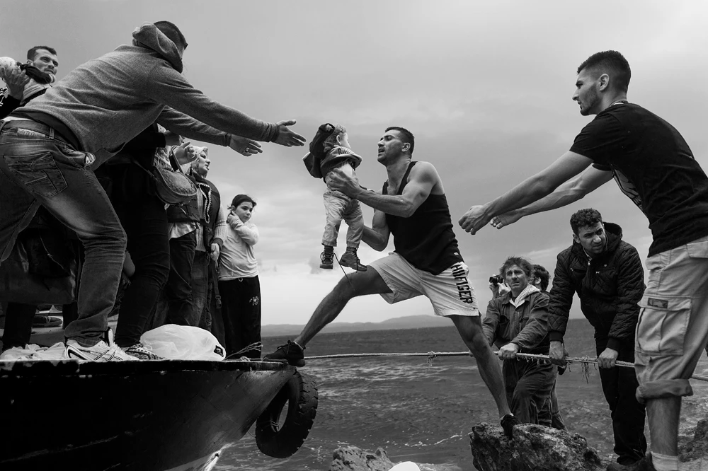 Salam Aldeen of the rescue group Team Humanity saves a child on the Greek Island of Lesvos at the height of the migrant crisis in 2015. (Getty Images)