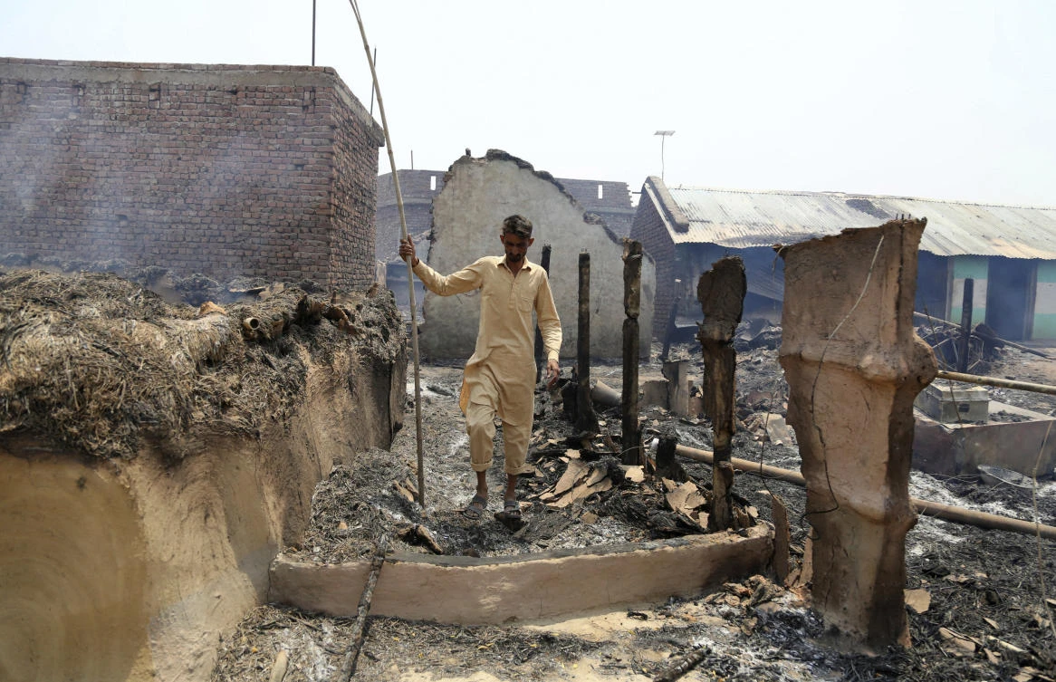 An Indian man inspects the damage after his home was gutted by firing allegedly from the Pakistan side of the border in the Ranbir Singh Pura district of Jammu and Kashmir on Tuesday, May 22. Villages along the India-Pakistan border are almost deserted as most have moved to safer areas. (AP)