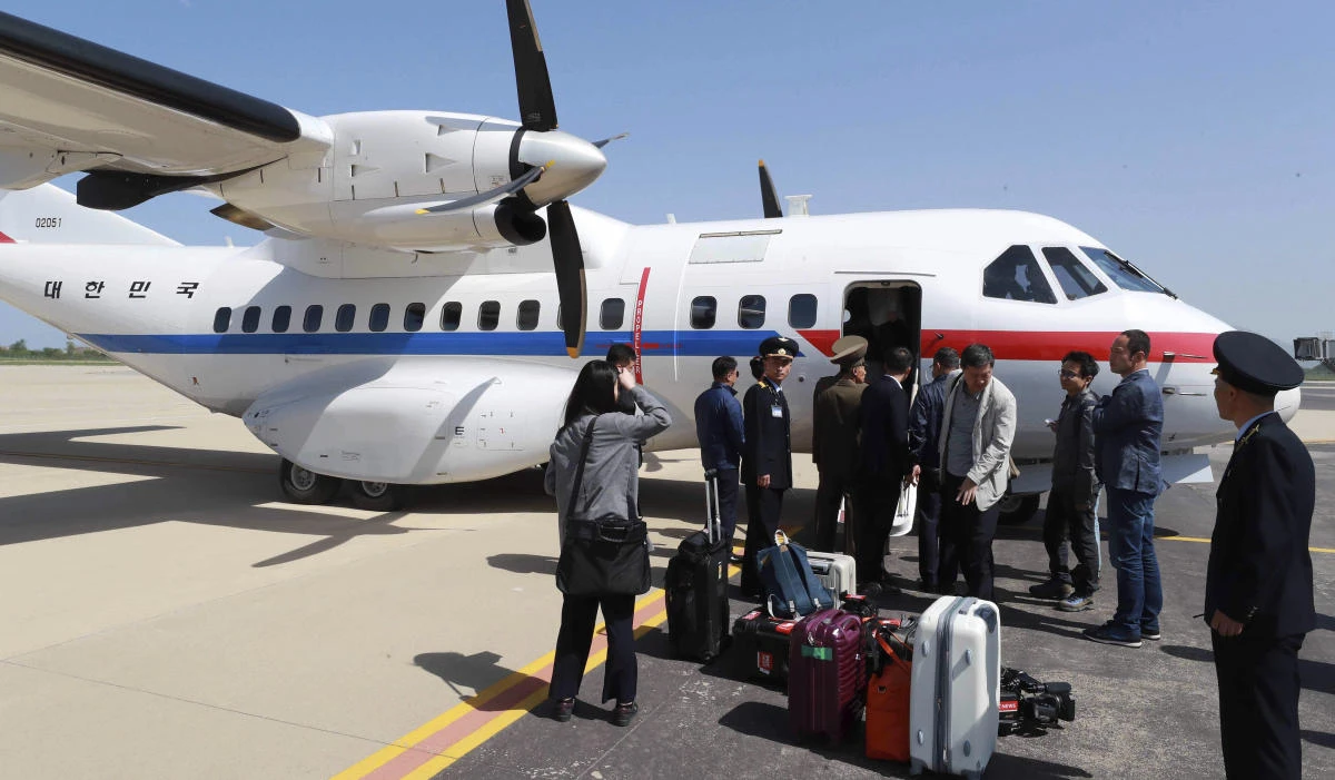 South Korean journalists arrive at the Kalma Airport in Wonsan, North Korea. Eight journalists from South Korea departed for rival North Korea after the North allowed them to join the small group of foreign media in the country to witness the dismantling of its nuclear test site this week. (Yonhap via AP)