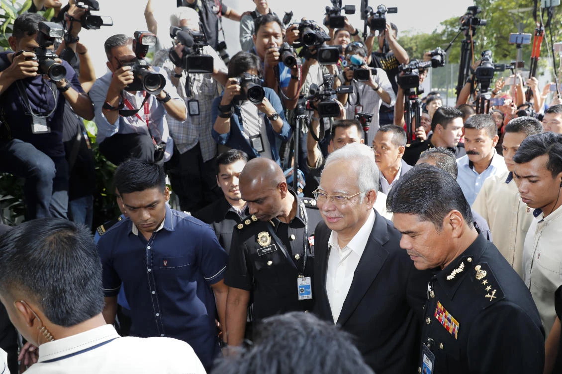 Former Malaysian Prime Minister Najib Razak, center, arrives at Malaysian Anti-Corruption Commission office in Putrajaya on Thursday, May 24 for questioning as part of the corruption and money-laundering investigation into the 1MDB state investment fund. (AP)