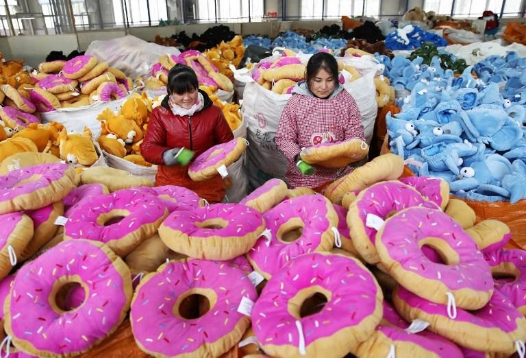 Workers perform quality check on toys for export at a factory in Lianyungang in east China’s Jiangsu province. (AFP)