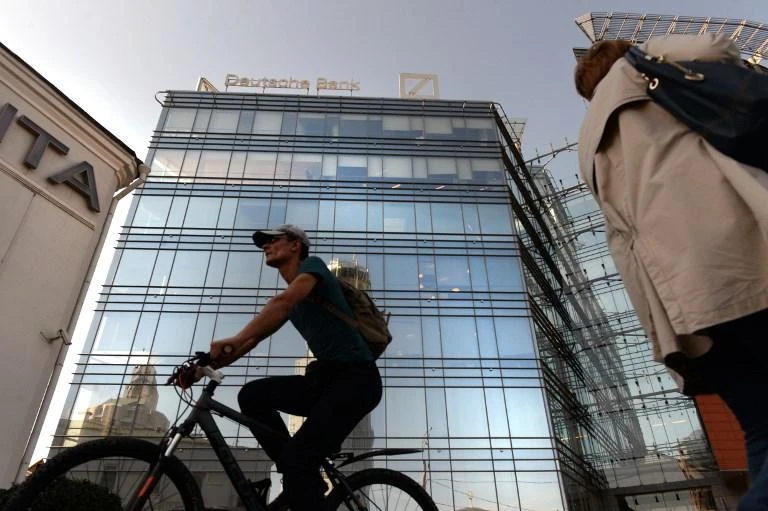 German financial giant Deutsche Bank that the ‘associated personnel reductions are underway.’ (AFP)