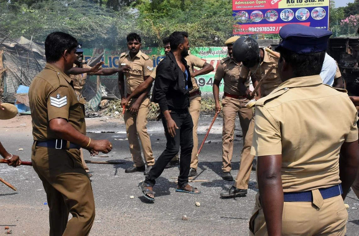 Police officials use ‘lathis’ — long bamboo sticks — as they clash with protesters in the southern Indian city of Tuticorin during a rally to demand the closure of a Vedanta Resources copper factory due to pollution concerns. (AFP)