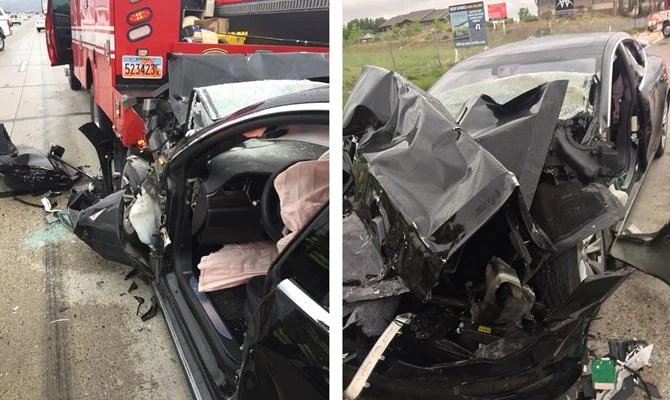 This combo image from photos released by the South Jordan Police Department showsa traffic collision involving a Tesla Model S sedan with a Fire Department mechanic truck that stopped at a red light in South Jordan, Utah. (South Jordan Police Department via AP)