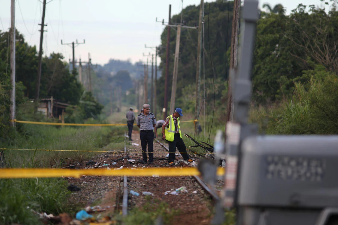 In this file photo, police officers stand at the site where a Boeing 737 plane crashed after taking off from Havana’s main airport on May 18, in the agricultural area of Boyeros, Cuba. (Reuters)