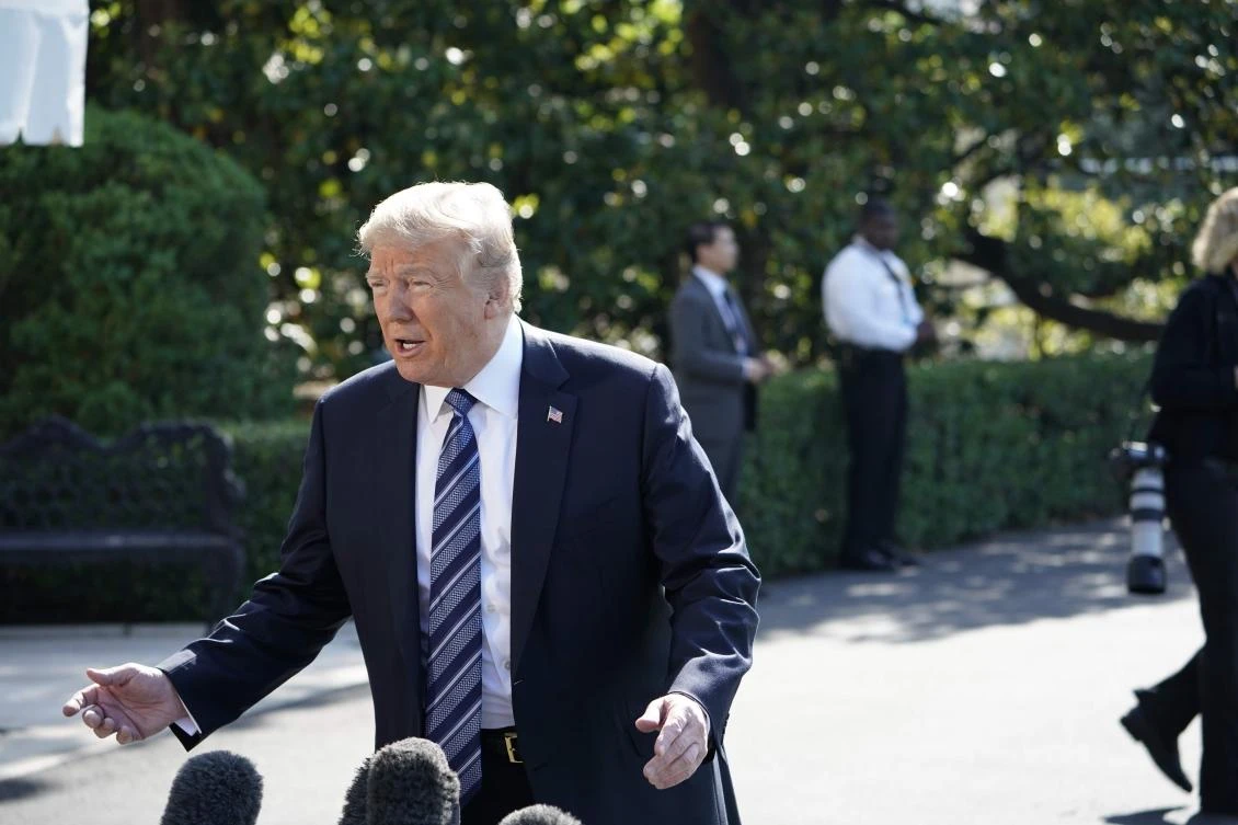 US President Donald Trump speaks to the press on his way to board Marine One from the South Lawn of the White House on May 25, 2018 in Washington, DC. Trump is heading to Annapolis, Maryland to attend the US Naval Academy graduation and commissioning ceremony. (AFP)