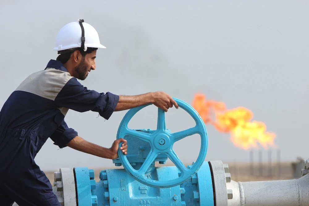 A worker checks a valve of an oil pipe in Iraq. (Reuters)