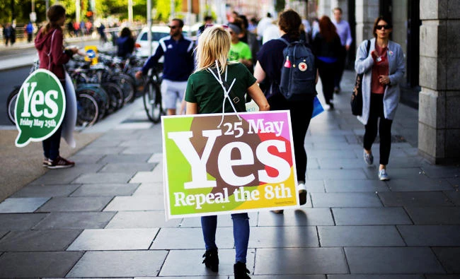 A woman carries a placard as Ireland holds a referendum on liberalising abortion laws, in Dublin, Ireland, on Friday. (REUTERS)
