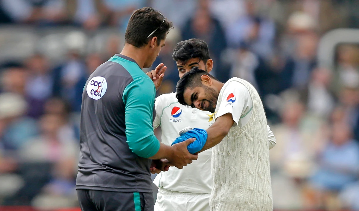 Pakistan’s Babar Azam reacts as ice is applied to an injury caused by a ball bowled by England’s Ben Stokes during the second day of play of the first test cricket match between England and Pakistan at Lord’s cricket ground in London, Friday, May 25, 2018. (AP)