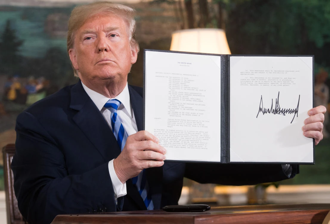 The moment US President Donald Trump signed the document reinstating sanctions against Iran. (Saul Loeb/AFP)