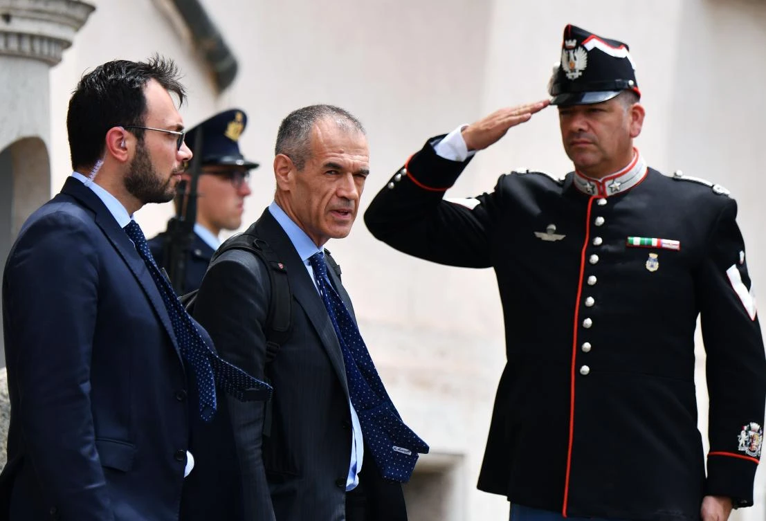 Italian economist, formerly with the International Monetary Fund, Carlo Cottarelli leaves the Qurinale presidential palace in Rome after a meeting with Italian President that gave him the mandate to form a new government. (AFP)