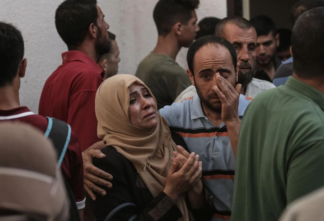 Palestinian relatives of Mohammed Al-Radeia, 30, mourn during his funeral in Beit Lahia in the northern Gaza Strip. Al-Radeia was killed by Israeli tank fire into northern Gaza, the health ministry in the Hamas-run enclave said. (AFP)