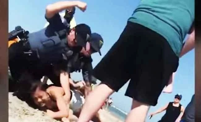 Police launch probe after video shows officer punching woman