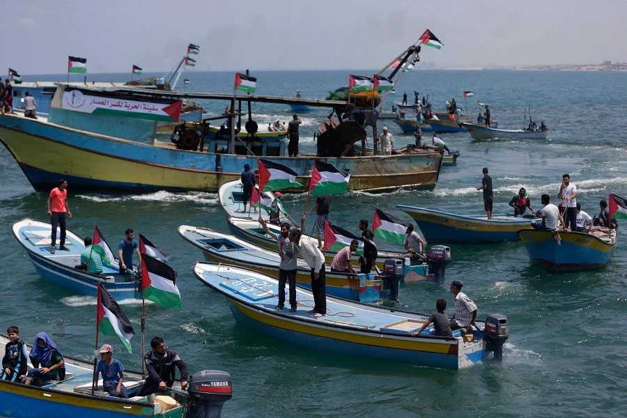 Fishing boats carrying a group of Palestinian activists who are protesting and perhaps trying to breach Israel's naval blockade on Gaza, setting to sail from Gaza City harbor. (AFP)