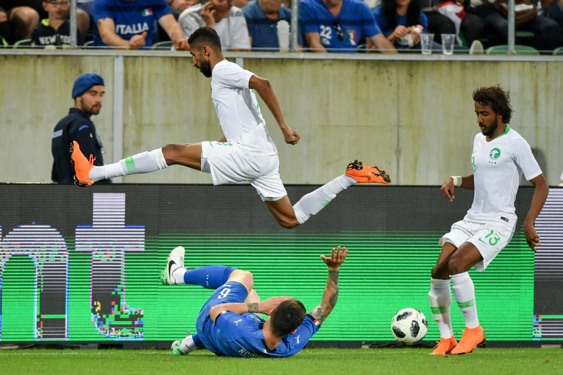 Saudi Arabia's midfielder Salman Al-Faraj jumps over Italy's defender Alessio Romagnoli during the friendly football match between Italy and Saudi Arabia at Kybunpark stadium in St Gallen on May 28, 2018. (AFP/Fabrice Coffrini)