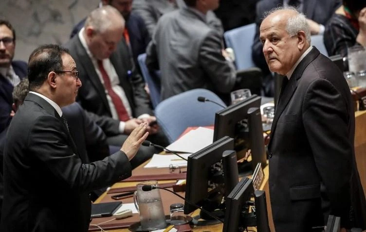 Ambassador of Kuwait to the United Nations Mansour Al-Otaibi, left, talks to Permanent Observer of Palestine to the United Nations Riyad Mansour at the start of a UN Security Council meeting concerning the violence at the border of Israel and the Gaza Strip, at United Nations headquarters on May 15. (Getty Images/AFP)