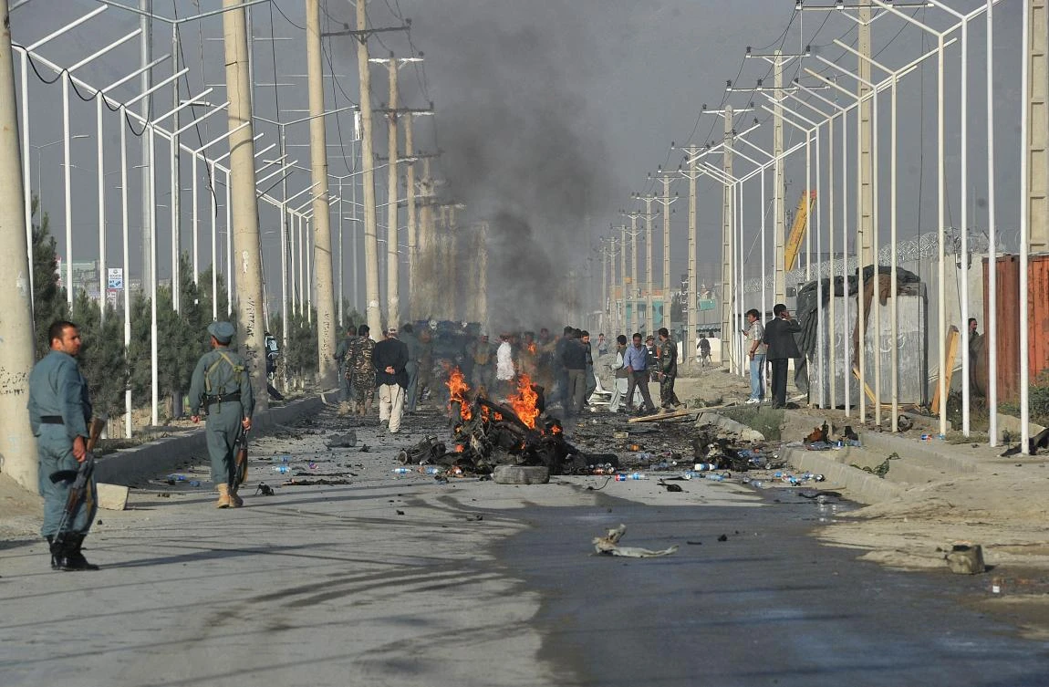 A minivan burns after a suicide bombing attack along a major highway leading to the Kabul international airport on Tuesday, killing several foreigners. (AFP)