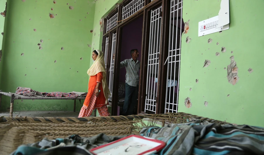 Indian villagers inspect the damage caused in cross border firing, during a lull in shelling between India and Pakistan in Samka village, in Ranbir Singh Pura district, India, on May 30, 2018. (AP)