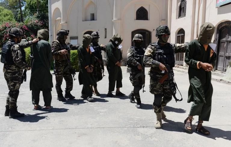 Members of the National Directorate Security escorts alleged Taliban fighters on May 23 after an operation in in Jalalabad against the militants. (AFP)