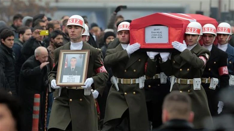An honor guard carries the coffin of a Turkish soldier killed in clashes with PKK fighters, in Ankara, in 2015. Three Turkish soldiers were killed Thursday by Kurdish rebels in northern Iraq. (AP Photo)