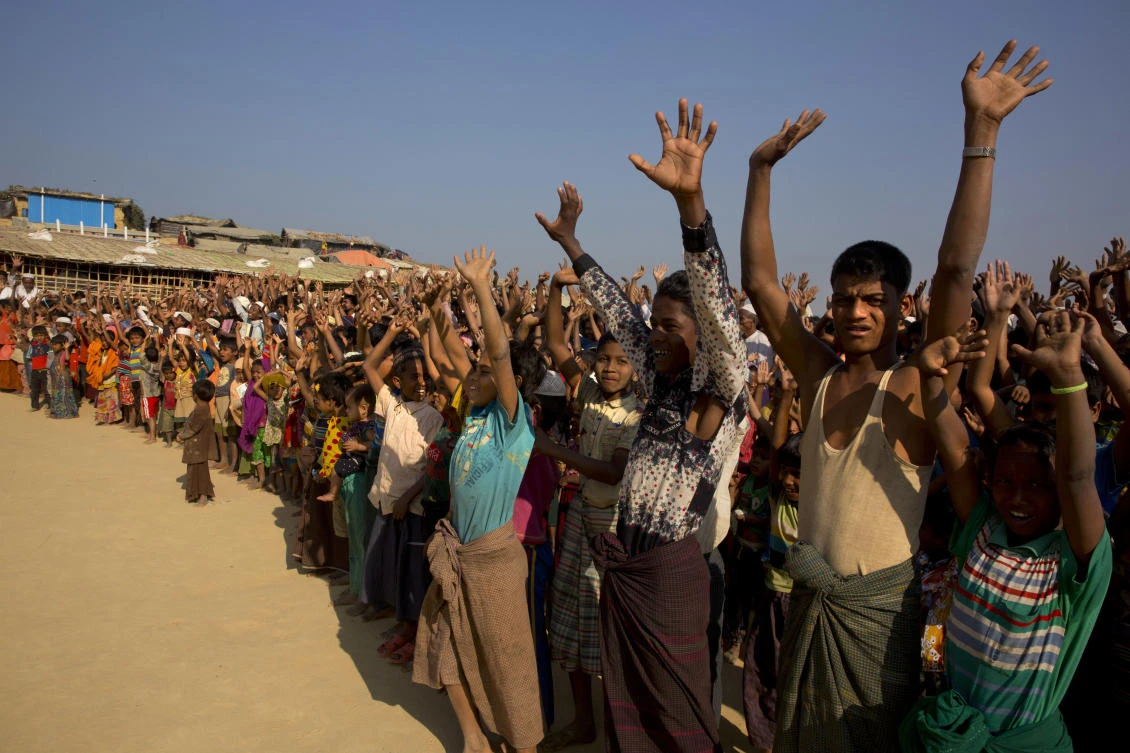 Rohingya refugees raise their hands and shout that they would not go back to Myanmar during a demonstration at Kutupalong near Cox’s Bazar in Bangladesh in this January 22 photo. (AP)