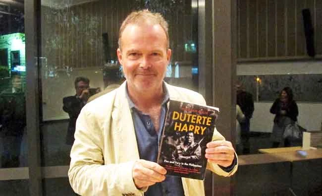 Author Jonathan Miller displays his biography of Rodrigo Duterte at a book-signing event on Thursday, May 31, 2018, at the Australian National University in Canberra, Australia. (AP)