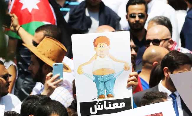 Thousands of Jordanians take to the streets in a week of mass protests against a new income tax draft law. AFP