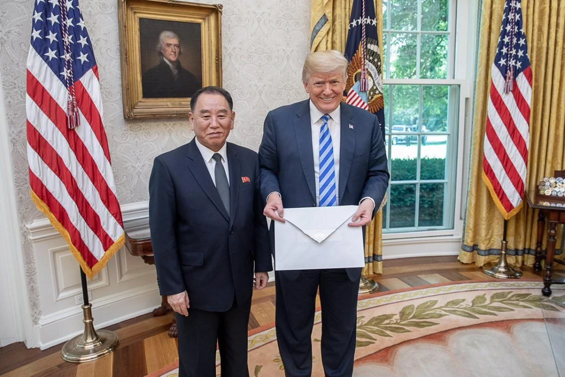 US President Donald Trump carrying a strangely large letter from North Korea's Kim Jong Un. (Courtesy: White House)
