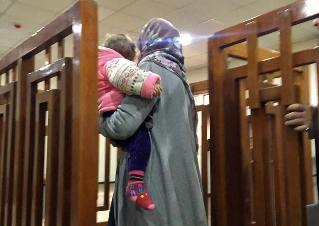 French Jihadist Melina Boughedir carriyng her son, arriving in court in the Iraqi capital Baghdad. (AFP)