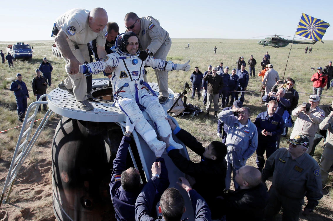 Ground personnel help International Space Station crew member Anton Shkaplerov of Russia to get out of the Soyuz MS-07 space capsule shortly after landing in a remote area outside the town of Dzhezkazgan, Kazakhstan June 3, 2018. (Reuters)