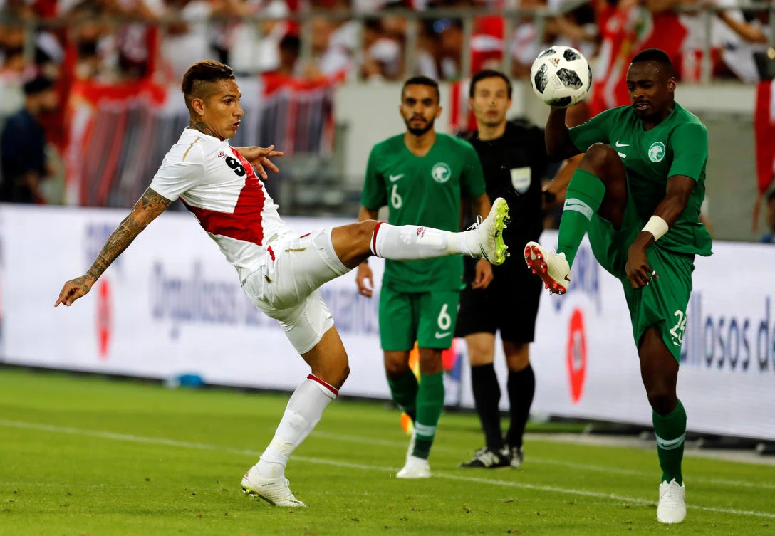 Two-goal Paolo Guerrero vies for possession with Saudi Arabia's Motaz Hawsawi. (Reuters)