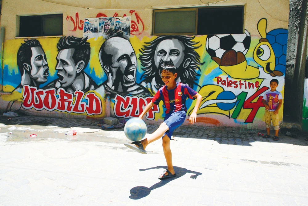 Palestinians idolize Lionel Messi and his Barcelona shirt is worn throughtout the territories. The striker playing for Argentina, left. (Getty Images)