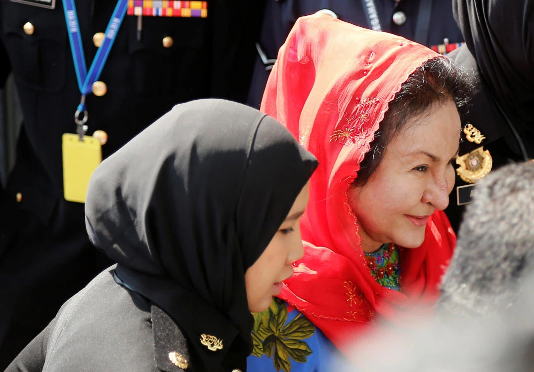 Rosmah Mansor, right, the wife of former Malaysian prime minister Najib Razak, arrives to give a statement to the Malaysian Anti-Corruption Commission in Putrajaya. Police found hundreds of luxury handbags, jewelry and cash during raids on apartments linked to the family. (Reuters)
